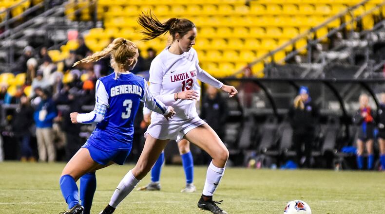 Lakota West’s Kailyn Dudukovich dribbles the ball defended by Anthony Wayne’s Emilie Gardner during their Division I State championship soccer game Saturday, Nov. 9, 2019 at MAPFRE Stadium in Columbus. Dudukovich scored both of Lakota West’s goals. NICK GRAHAM/STAFF