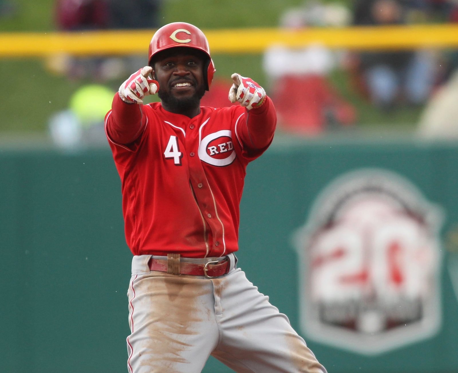 The Reds’ Brandon Phillips points to a teammate at third base after an RBI hit in the third inning against the Pirates in an exhibition game at Victory Field in Indianapolis on Saturday, April 2, 2016. David Jablonski/Staff