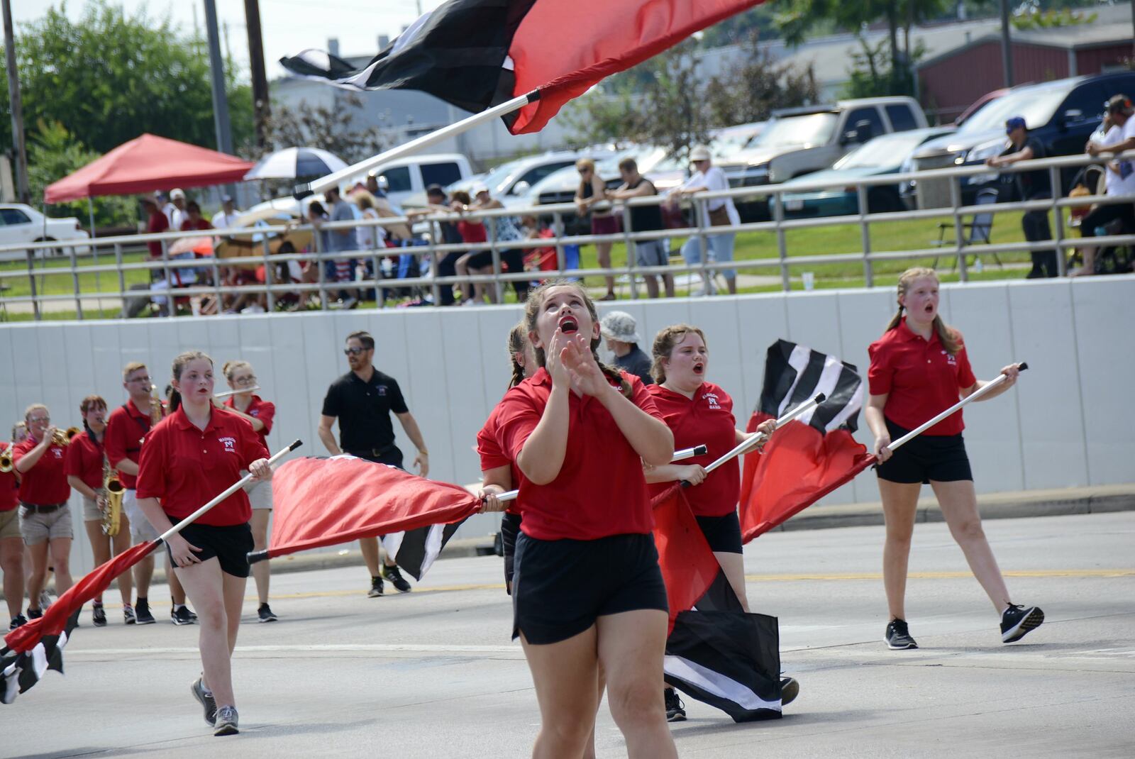 Hamilton’s annual Fourth of July parade on July 4, 2018, attracted hundreds from around the region, and included multiple high school marching bands, police agencies, and veterans and veteran organizations. Pictured is a member of the Madison High School color guard getting ready to catch her flag during the parade. MICHAEL D. PITMAN/STAFF