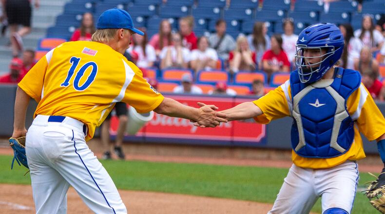 Russia pitcher Xavier Phlipot and catcher Cooper Unverferth celebrate getting out of a jam in the sixth inning of their 1-0 victory in eight innings over St. Henry in the Division IV semifinals at Canal Park in Akron. Jeff Gilbert/CONTRIBUTED