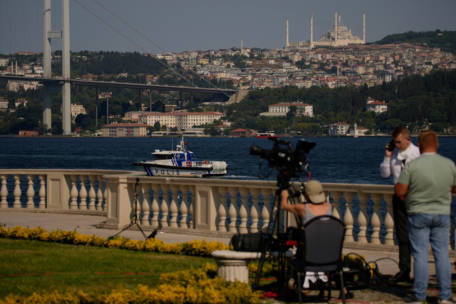 A police boat patrols the Bosphorus as journalists work at the at Ciragan palace ahead of expected talks between Russian and Ukrainian delegations, in Istanbul, Turkey, Wednesday, July 23, 2025. (AP Photo/Emrah Gurel)