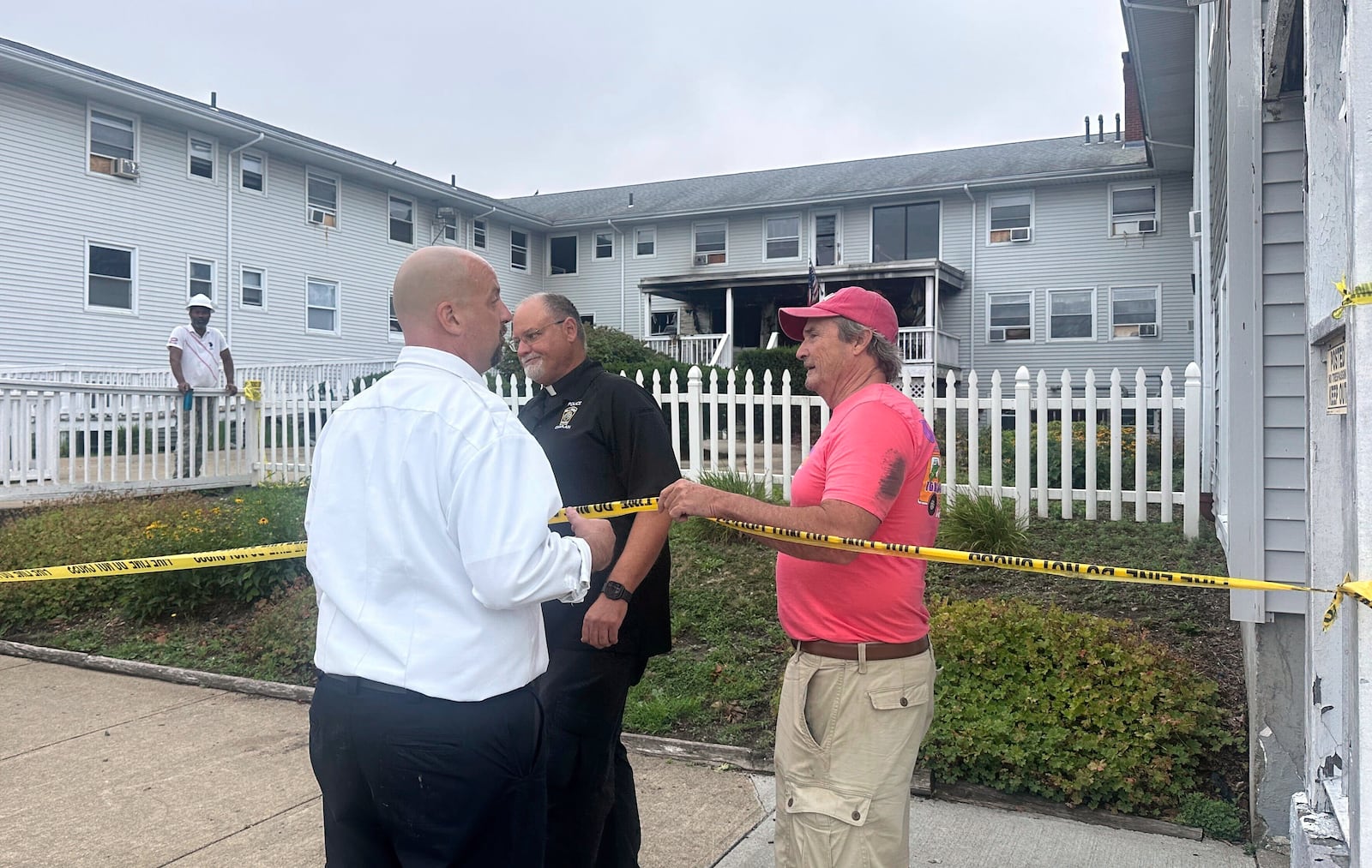 Dennis Etzkorn, owner of Gabriel House, right, visits the site in the aftermath of a fire alongside Fall River Fire Chief Jeffrey Bacon, left, Monday, July 14 in Fall River, Mass, (Michael Casey)