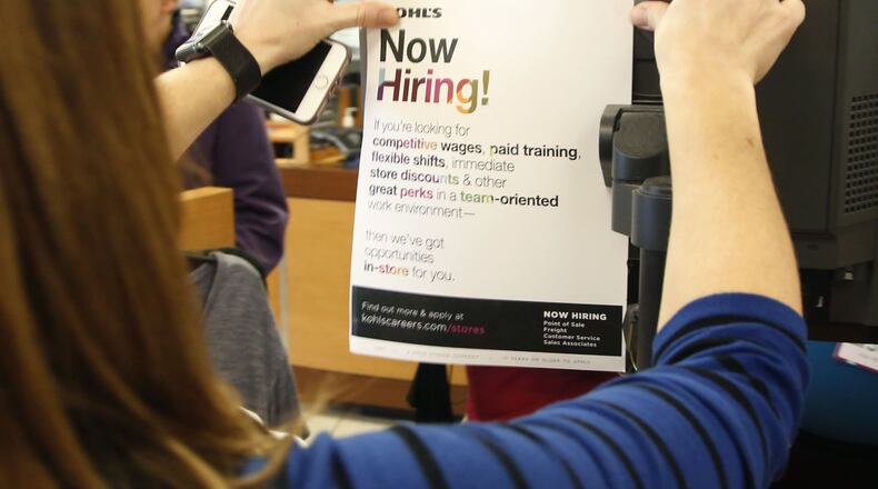 Kohl’s store manager Brandy Duran posts a job flyier at the Centerville store. There’s still time to jump on the holiday job train, with retailers, distribution centers and fulfillment centers looking to hire thousands in the Dayton area as the peak of the holiday shopping season rapidly approaches. With low unemployment and increasing online sales, an increase in seasonal jobs is being seen across the board, though many positions could go unfilled with the number of permanent open jobs. TY GREENLEES / STAFF