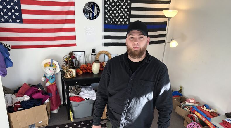 Kyle Brummett, owner of Blueline Protection Services/Intelligence Risk Management, a security and private investigation company based at 1321 Central Ave., isn’t sure how much longer the clothing and toy drive will be allowed to operate out of the front of his business. RICK McCRABB/STAFF