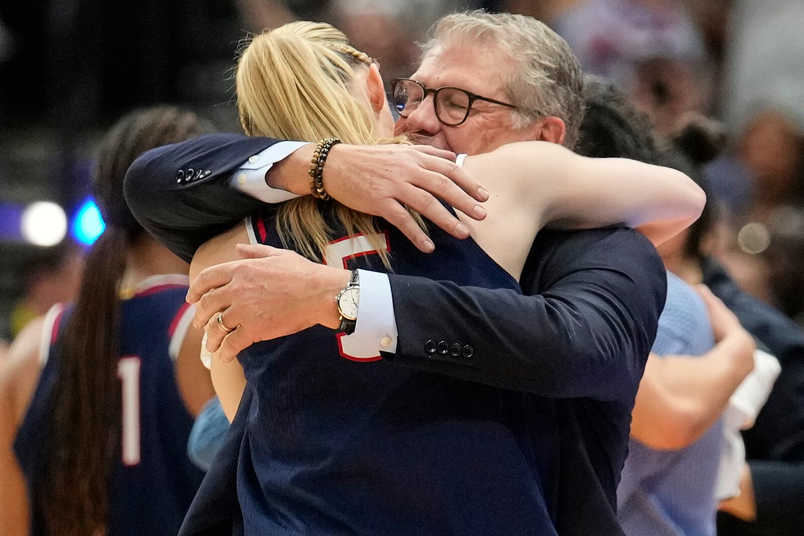 UConn head coach Geno Auriemma hugs UConn guard Paige Bueckers (5) as she comes off the floor late in the second half of the national championship game against South Carolina at the Final Four of the women's NCAA college basketball tournament, Sunday, April 6, 2025, in Tampa, Fla. (AP Photo/Chris O'Meara)
