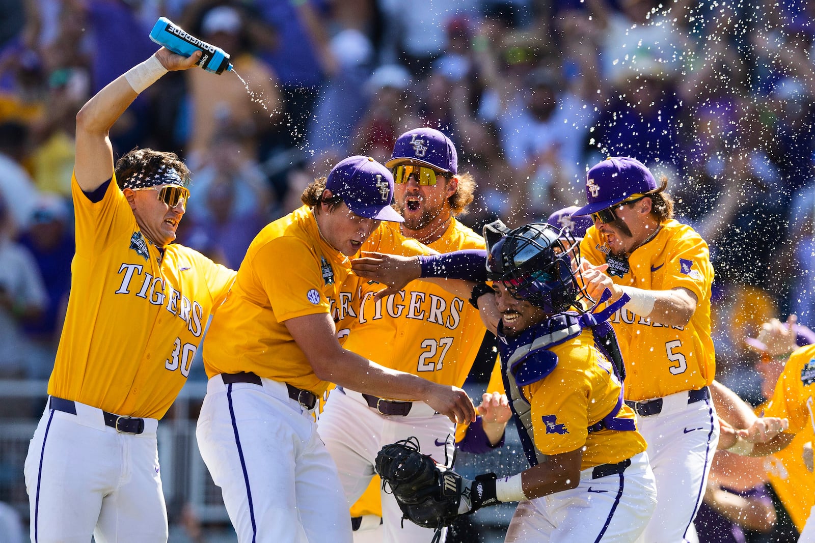 LSU players celebrate their 5-3 win over Coastal Carolina in Game 2 of the NCAA College World Series baseball finals in Omaha, Neb., Sunday, June 22, 2025. (AP Photo/Rebecca S. Gratz)