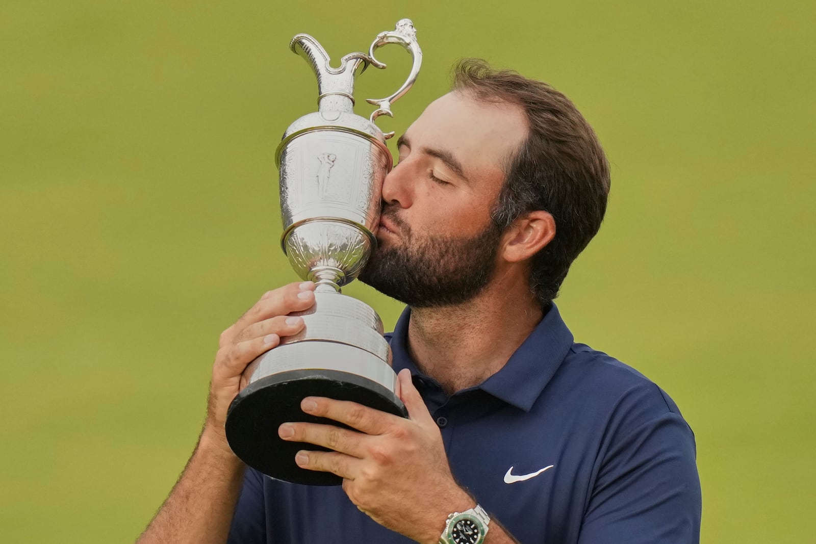 Scottie Scheffler of the United States kisses the trophy as he poses for photographers with the Claret Jug after winning the British Open golf championship at the Royal Portrush Golf Club, Northern Ireland, Sunday, July 20, 2025. (AP Photo/Francisco Seco)