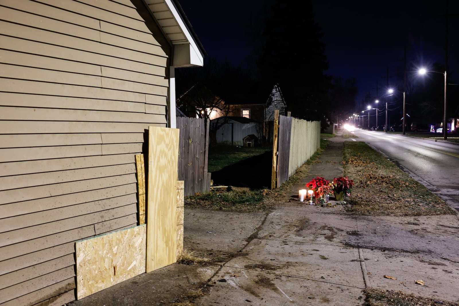 Flowers and candles were left near the intersection of River Road and Hooven Avenue on Sunday, Dec. 21, 2025. The area was the site of a crash that killed three people earlier in the day. NICK GRAHAM / STAFF