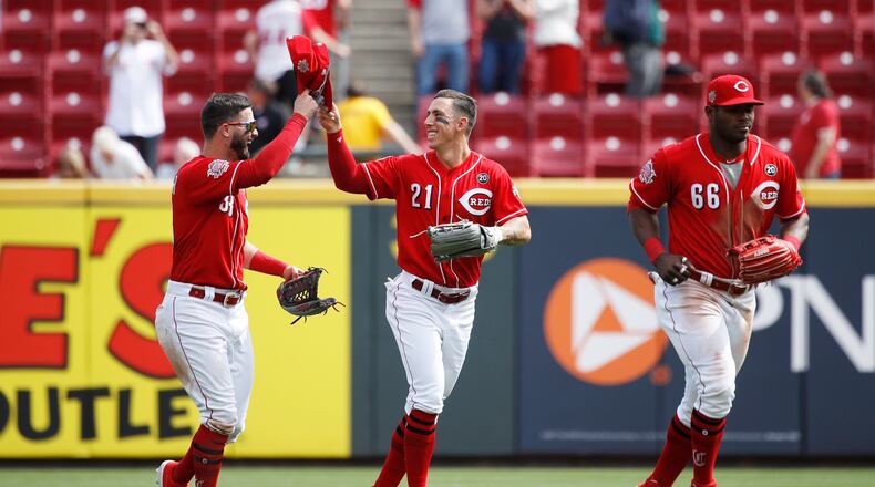 CINCINNATI, OH - APRIL 11: Michael Lorenzen #21, Jesse Winker #33 and Yasiel Puig #66 of the Cincinnati Reds celebrate after the game against the Miami Marlins at Great American Ball Park on April 11, 2019 in Cincinnati, Ohio. The Reds won 5-0. (Photo by Joe Robbins/Getty Images)