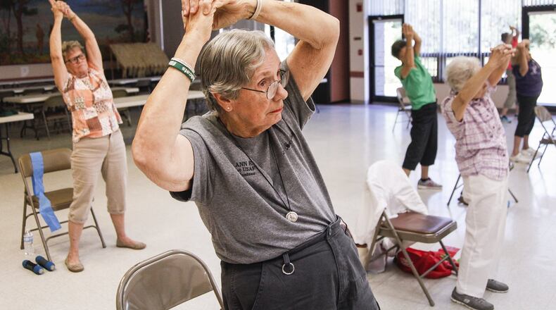 Ann Foster, who retired from the Air Force, credits activities like exercise classes at the Fairborn Senior Center and volunteer work at 4 Paws for Ability in Xenia, the Fairborn Historical Society and others with keeping her engaged in the community. CHRIS STEWART / STAFF