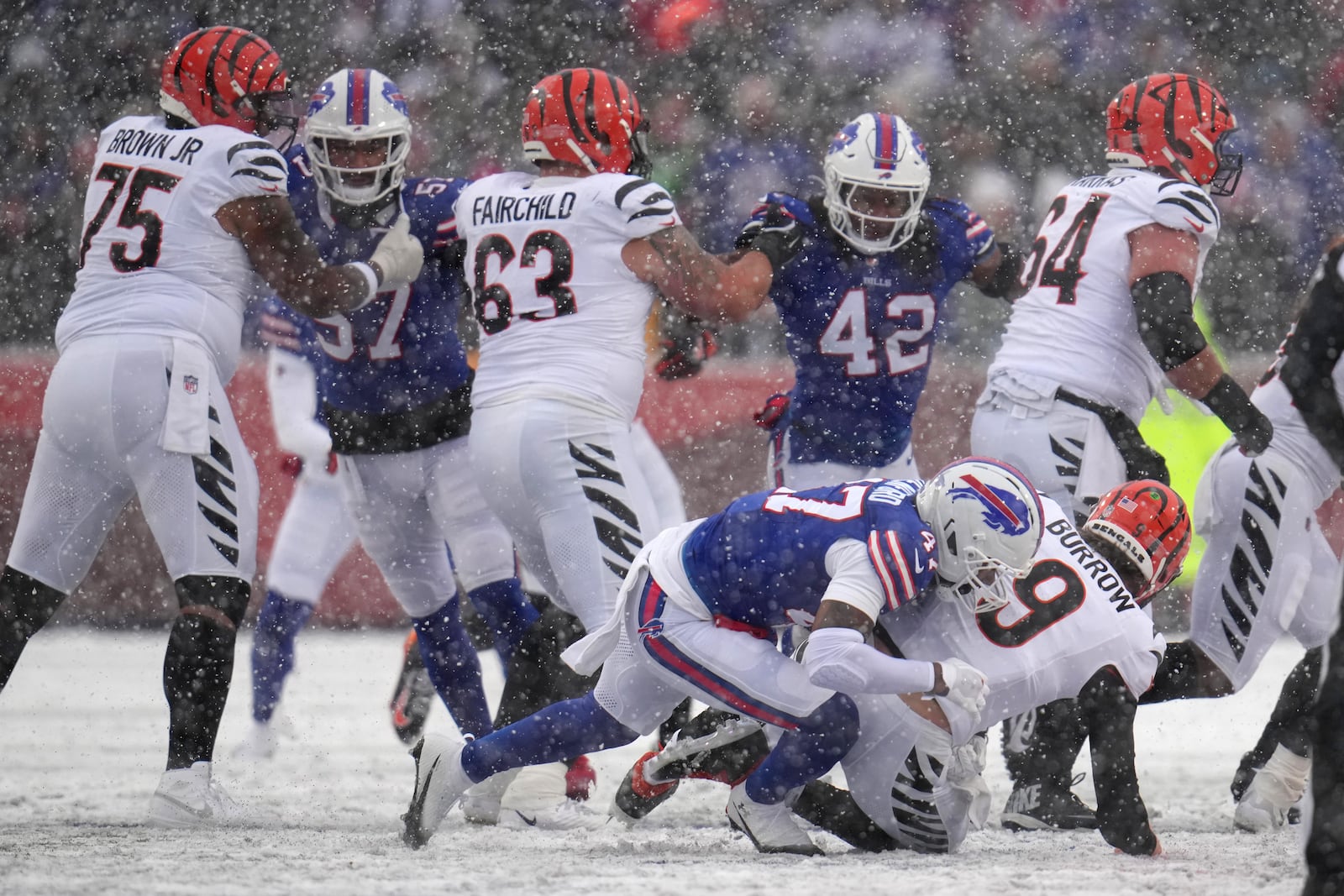 Cincinnati Bengals quarterback Joe Burrow (9) is sacked by Buffalo Bills cornerback Christian Benford (47) during the first half of an NFL football game, Sunday, Dec. 7, 2025, in Orchard Park, N.Y. (AP Photo/Gene J. Puskar)