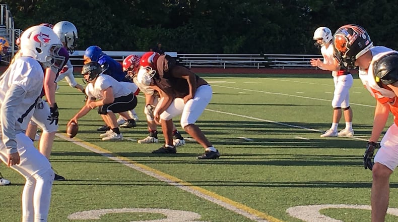 Franklin’s Nathaneel Rudd prepares to snap the ball during an East practice Monday at Moeller High School. RICK CASSANO/STAFF