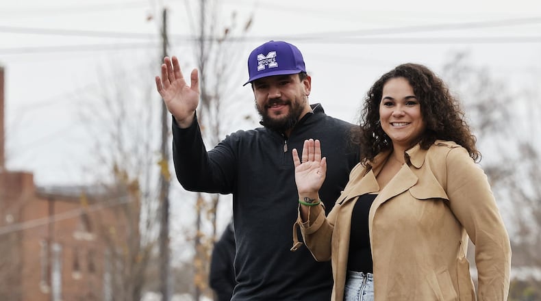 Kyle Schwarber and wife, Paige, wave at the crowd during the Middletown Santa Parade Saturday, Nov. 26, 2022 in downtown Middletown. Middletown native Kyle Schwarber served as grand marshal. NICK GRAHAM/STAFF