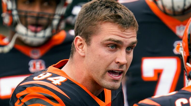 FILE - Cincinnati Bengals defensive end Sam Hubbard (94) talks with a teammate before an NFL football game against the Dallas Cowboys in Cincinnati, in this Sunday, Dec. 13, 2020, file photo. The Bengals on Monday, July 26, 2021, announced a four-year contract extension for Hubbard.(AP Photo/Bryan Woolston, File)