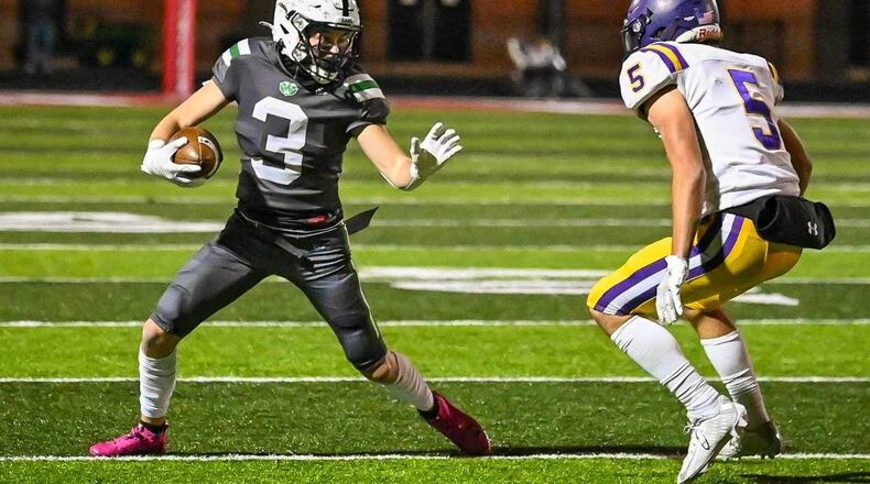 Badin's Austin Buckle (3) tries to elude Bellbrook defender Johnny Descz (5) during a Division III regional quarterfinal game on Friday. Betsey Miyahara/CONTRIBUTED