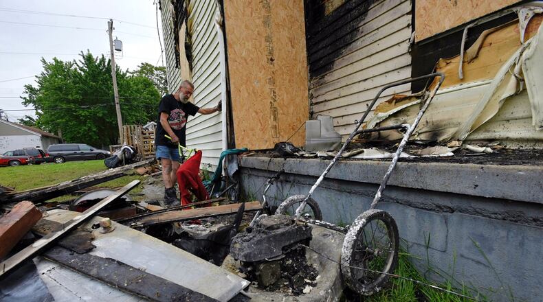 Jim Humphrey looks over the damage after a fire Wednesday night, May 10, at his home on Ludlow Street in Hamilton. He says in the four months he has lived at the home, he has often had to run vandals off the property.