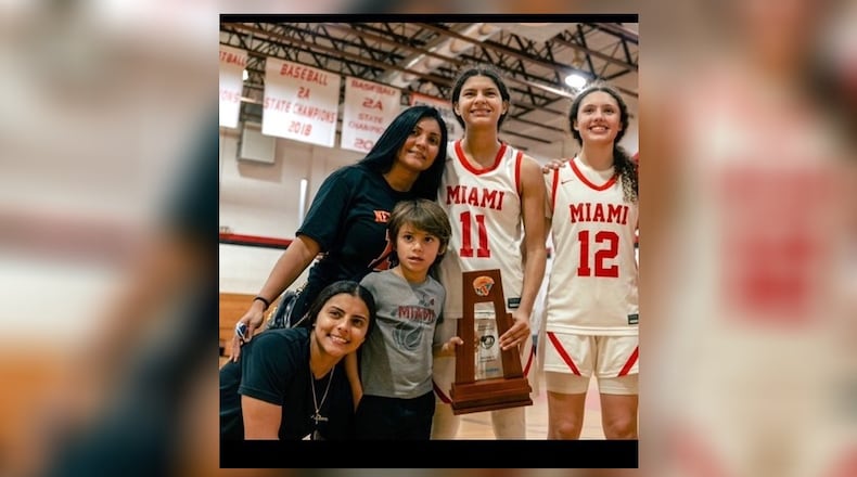 Delores “Lola” Montadas (standing, dark shirt) with her four children: her Miami RedHawks daughters, Enjulina (No. 11) and Ziul (No. 12); and in front, oldest daughter, Sabrina, a City of Miami firefighter and 10-year-old son, Jayden. CONTRIBUTED