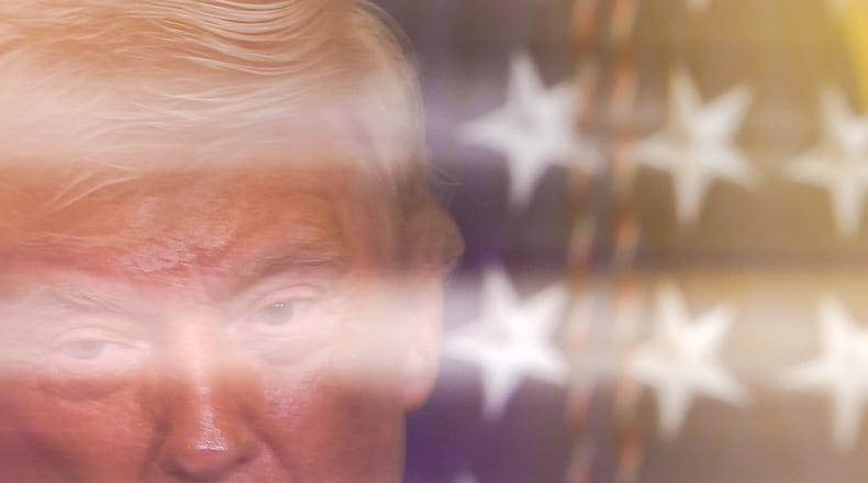 In this image taken with a slow shutter speed, President Donald Trump speaks during a women's history month event in the East Room of the White House, Thursday, March 12, 2026, in Washington. (AP Photo/Julia Demaree Nikhinson)