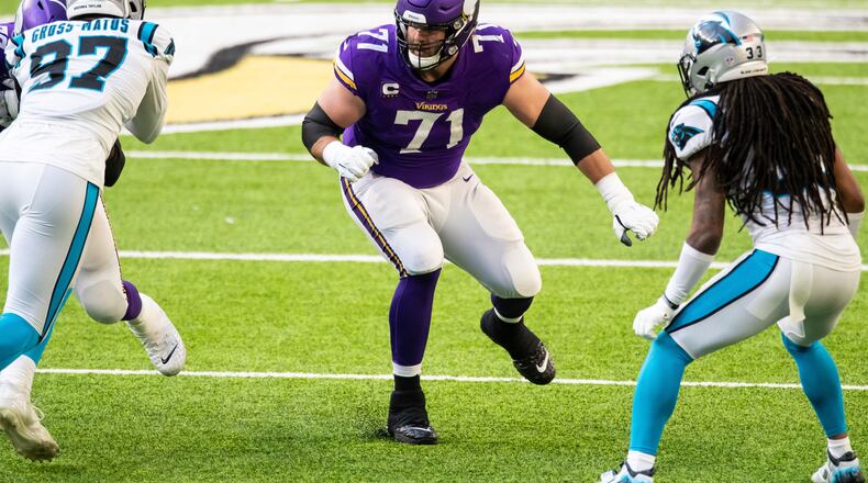 File-This Nov. 29, 2020, file photo shows Minnesota Vikings offensive tackle Riley Reiff (71) in action in the third quarter of an NFL football game against the Carolina Panthers in Minneapolis. Cincinnati bolstered its offensive line, which was a glaring weakness in a 4-11-1 2020 season, with the signing of ex-Vikings Reiff as the team seeks better protection for quarterback Joe Burrow.  (AP Photo/David Berding, File)