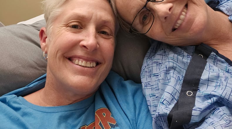 Julie Michael (right) with her partner, Elisa Jackson. Michael was diagnosed with both breast cancer and abdominal mesothelioma in 2024. She underwent surgeries and treatments for both cancers last year. CONTRIBUTED