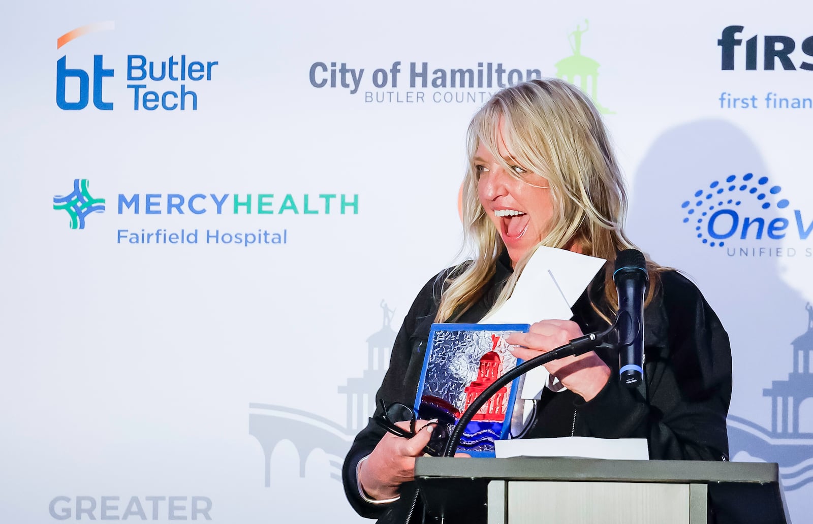 Kirsten Spicer, owner of Two Women in a Kitchen, speaks to the crowd after being announced as Small Business person of the year during the Greater Hamilton Chamber of Commerce annual meeting Friday, Jan. 31, 2025 at Spooky Nook Sports Champion Mill in Hamilton. David Stark was honored as Hamilton Citizen of the Year and Kirsten Spicer was honored as Small Business Person of the Year. NICK GRAHAM/STAFFNICK GRAHAM/STAFF