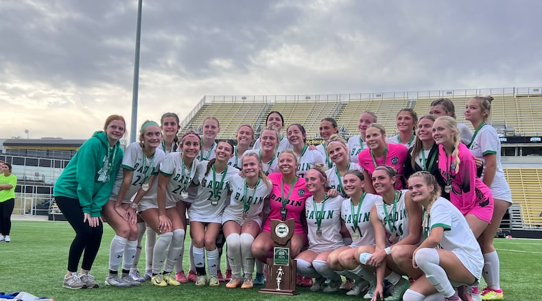The Badin High School girls soccer team poses with the runner-up trophy after the Division III state championship game on Saturday, Nov. 8 at Historic Crew Stadium in Columbus. The Rams lost to Bay Village Bay 1-0. CHRIS VOGT / CONTRIBUTED PHOTO