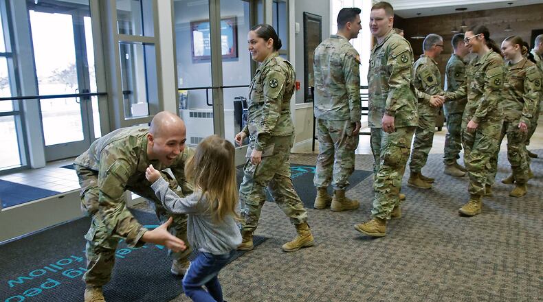 Amelia Bernabei runs into the arms of her father, SSgt. Joey Bernabei, Friday, Jan. 12, 2024 at the conclussion of a Call To Duty Ceremony honoring the Ohio Army National Guard's 1137th Signal Company who are deploying for nine months in Support of U.S. Central Command. About 30 members of the Springfield Company are deploying and participated in the ceremony at The First Christian Church on Middle Urbana Road. BILL LACKEY/STAFF