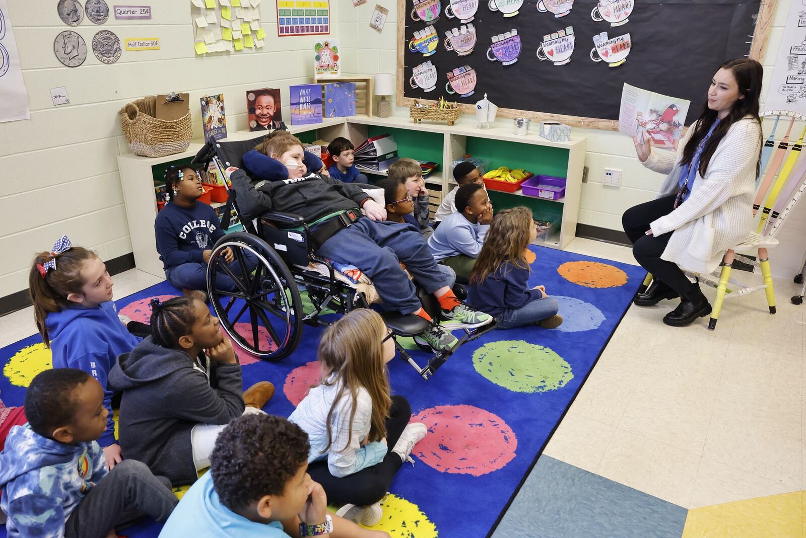 Rydder Ames, a 7-year-old battling a rare brain disease called DMG, visited his second-grade classroom at Brookwood Elementary Tuesday, Jan. 24, 2023 to receive handmade birthday cards from his classmates and listen to a story read by his teacher Piper Van Der Veer. NICK GRAHAM/STAFF