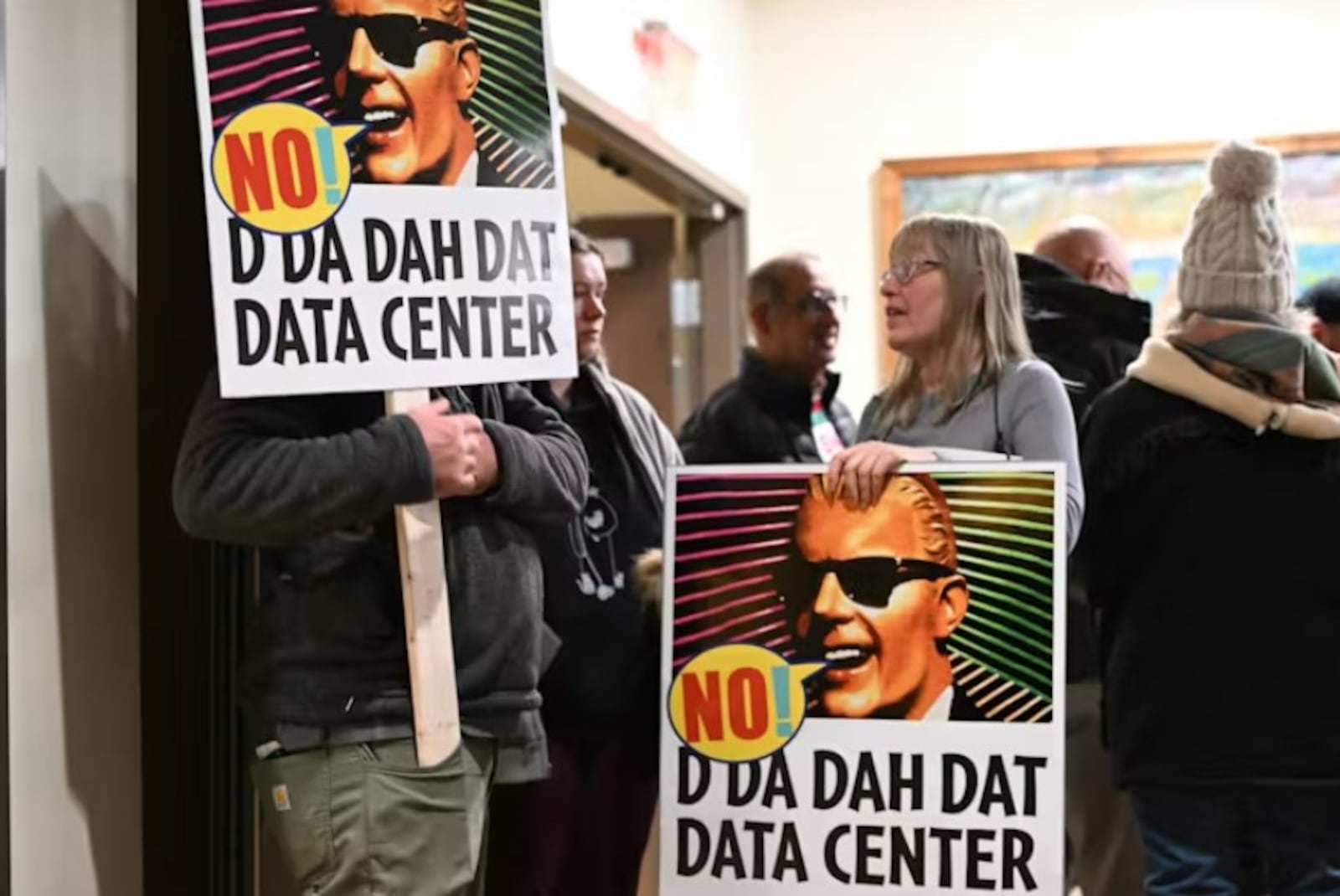 People opposed to a data center proposal at the former Pennhurst state hospital grounds talk during a break in an East Vincent Township supervisors meeting in December 2025 in Spring City, Pa. ASSOCIATED PRESS FILE
