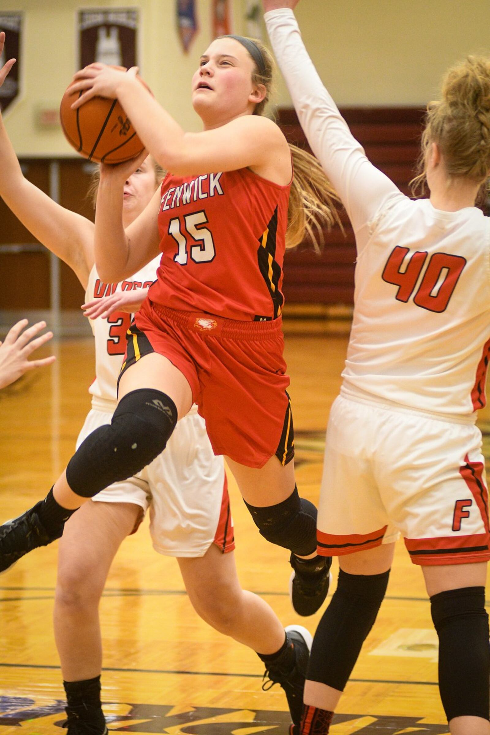 Fenwick’s Hannah Beckman (15) drives for a shot as Franklin’s Emily Newton (40) defends during Monday night’s Division II district basketball semifinal at Lebanon. Franklin won 47-35. ROB MCCULLEY/RAM PHOTOGRAPHY