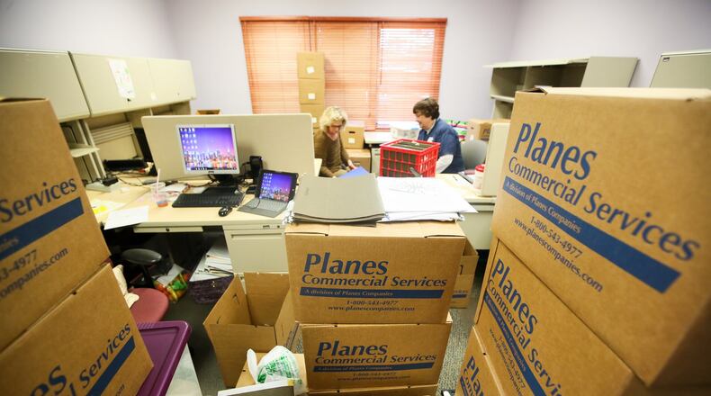 Candace Swan and Cheryl Guendelsberger pack up the Hamilton satellite office of the Butler County Board of Developmental Disabilities on March 9 in preparation of their move to the office on Liberty-Fairfield Road. GREG LYNCH / STAFF