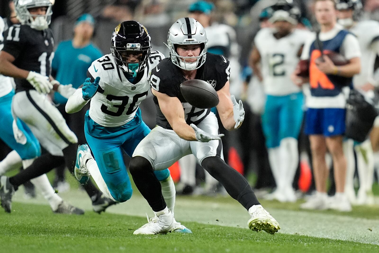 FILE - Las Vegas Raiders tight end Brock Bowers, right, makes a catch in front of Jacksonville Jaguars cornerback Montaric Brown (30) during the second half of an NFL football game Sunday, Dec. 22, 2024, in Las Vegas. The Raiders won 19-14.(AP Photo/John Locher, File)