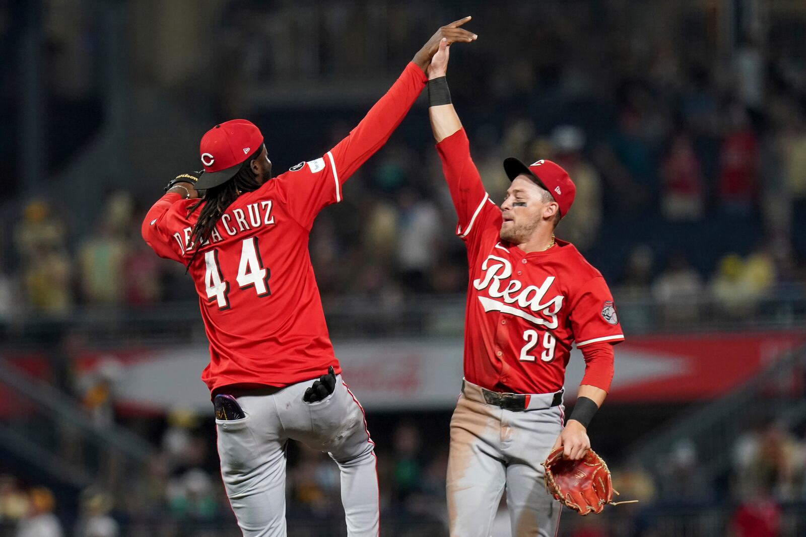 Cincinnati Reds shortstop Elly De La Cruz, left, celebrates with center fielder TJ Friedl, right, after defeating the Pittsburgh Pirates in a baseball game Saturday, Aug. 9, 2025, in Pittsburgh. (AP Photo/Matt Freed)