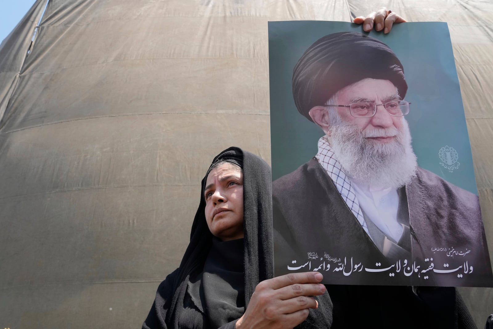 An Iranian protester holds up a poster of the Supreme Leader Ayatollah Ali Khamenei in an anti-Israeli gathering in Tehran, Iran, Friday, June 13, 2025. (AP Photo/Vahid Salemi)