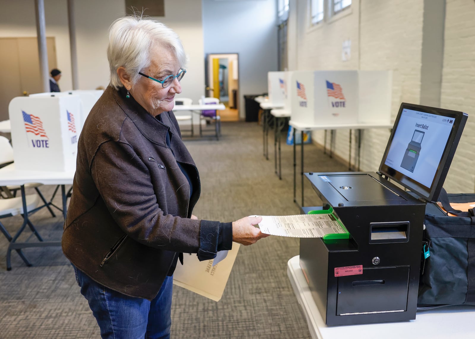 D'Arcy Fallon places her ballot in a machine after voting at the Clark County Heritage Center on Tuesday, November 4, 2025. JOSEPH COOKE/STAFF