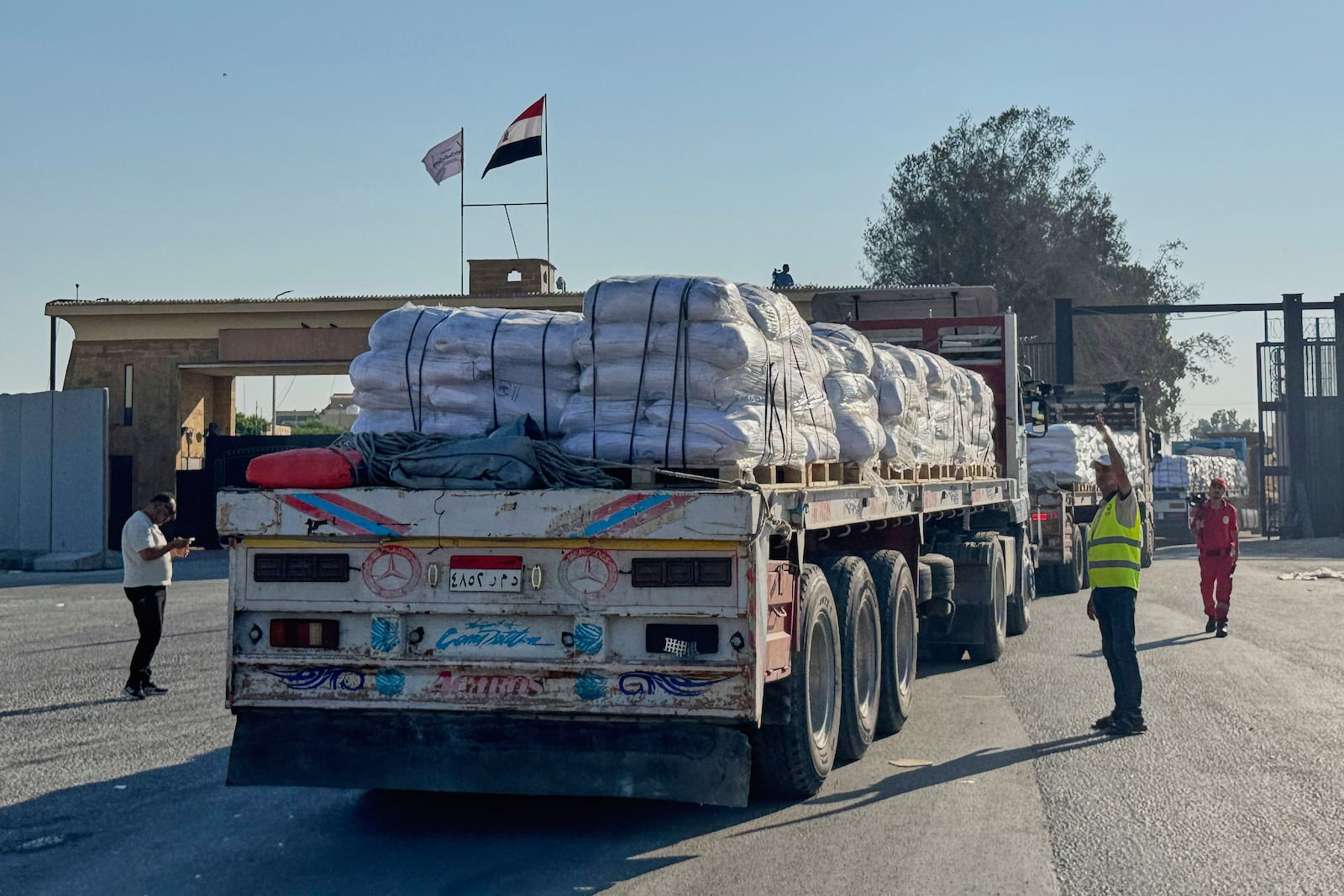 Trucks carrying humanitarian aids enter the Rafah crossing between Egypt and the Gaza Strip, Sunday, July 27, 2025. (AP Photo/Mohamed Arafat)