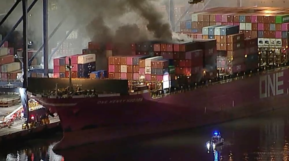 This image taken from video provided by ABC7 shows smoke rising from a blaze on a container ship docked at the Port of Los Angeles, Friday, Nov. 21, 2025, in Los Angeles. (ABC7 via AP)