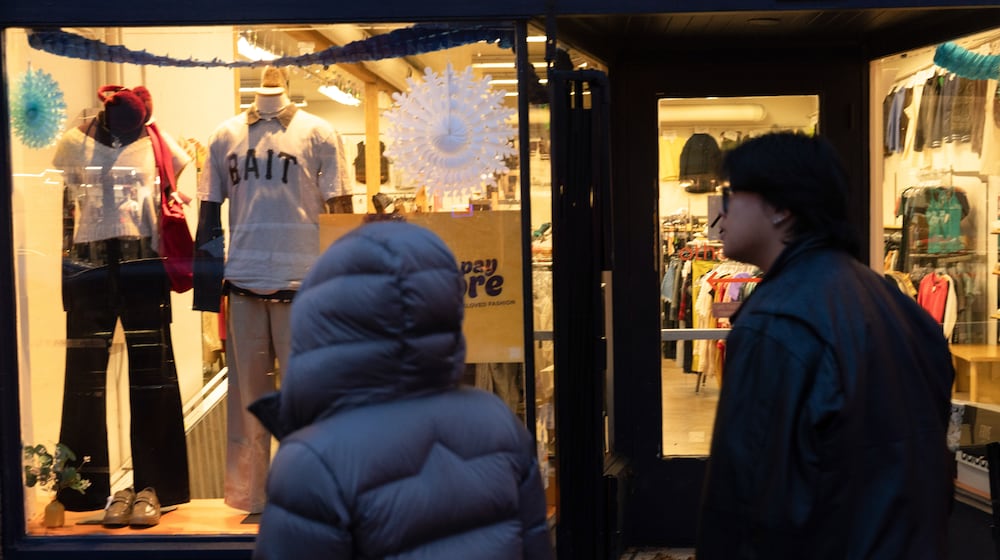 People walk by a shop on Tuesday, Jan. 6, 2026, in Portland, Ore. (AP Photo/Jenny Kane)