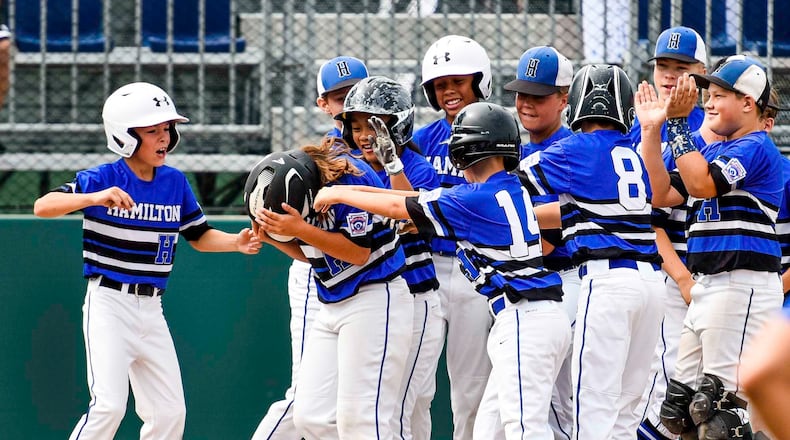 West Side Little League All-Stars are hoping for more celebrating as the Hamilton team prepares to play in its fifth Little League World Series. Four years ago, teammates wait at home plate after West Side Little League's Jaycee Taylor hit a 2-run home run during their 10-2 win over Grosse Pointe Woods/Shores Little League, from Michigan, in their Little League Great Lakes Regional tournament in Westfield, Ind. NICK GRAHAM/STAFF