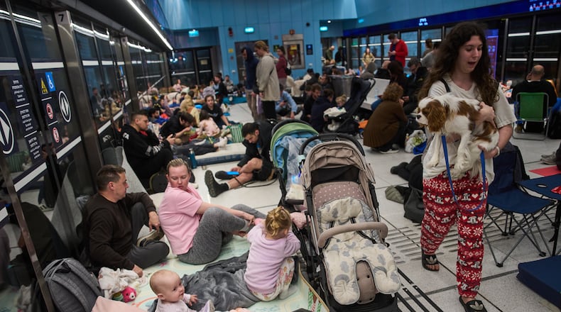 People take shelter in an underground metro station as air raid sirens warn of incoming strikes by Iran, in Ramat Gan, Israel, Saturday, Feb. 28, 2026. (AP Photo/Oded Balilty)