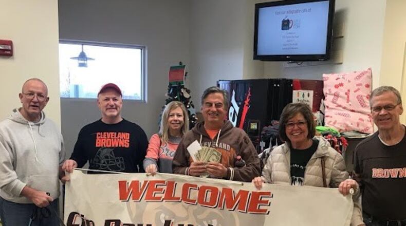 The Cin-Day Lucky Dawg Browns Backers of Mason have a “swear jar” into which members make a financial “donation” whenever they cuss while watching Browns games at the club’s Lucky Dog Grille headquarters in Mason. In all those losing years of the past, that jar – said Kurt Boveington (pictured on right), president of the club since 2011 – would be filled every week. At the end of each season the club donates the money and a truckload of dogfood to a local animal shelter. Pictured here are (left to right) are Bill Mahlock, Greg Soltis, Patty Soltis, Danny Dunn, Jodie Dunn and Boveington dropping off donations at The Animal Friends Shelter in Hamilton. CONTRIBUTED