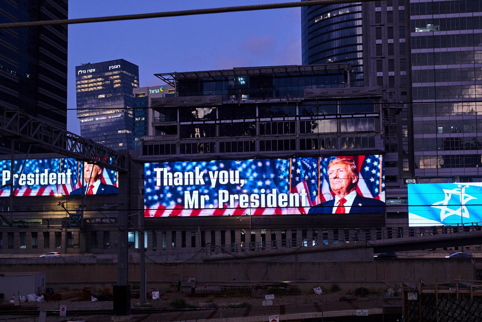 An electronic billboard beams an image of President Donald Trump alongside the message "Thank you, Mr. President" referring to the U.S. involvement in the war between Israel and Iran, in Ramat Gan, Israel, Sunday, June 22, 2025. (AP Photo/Bernat Armangue)