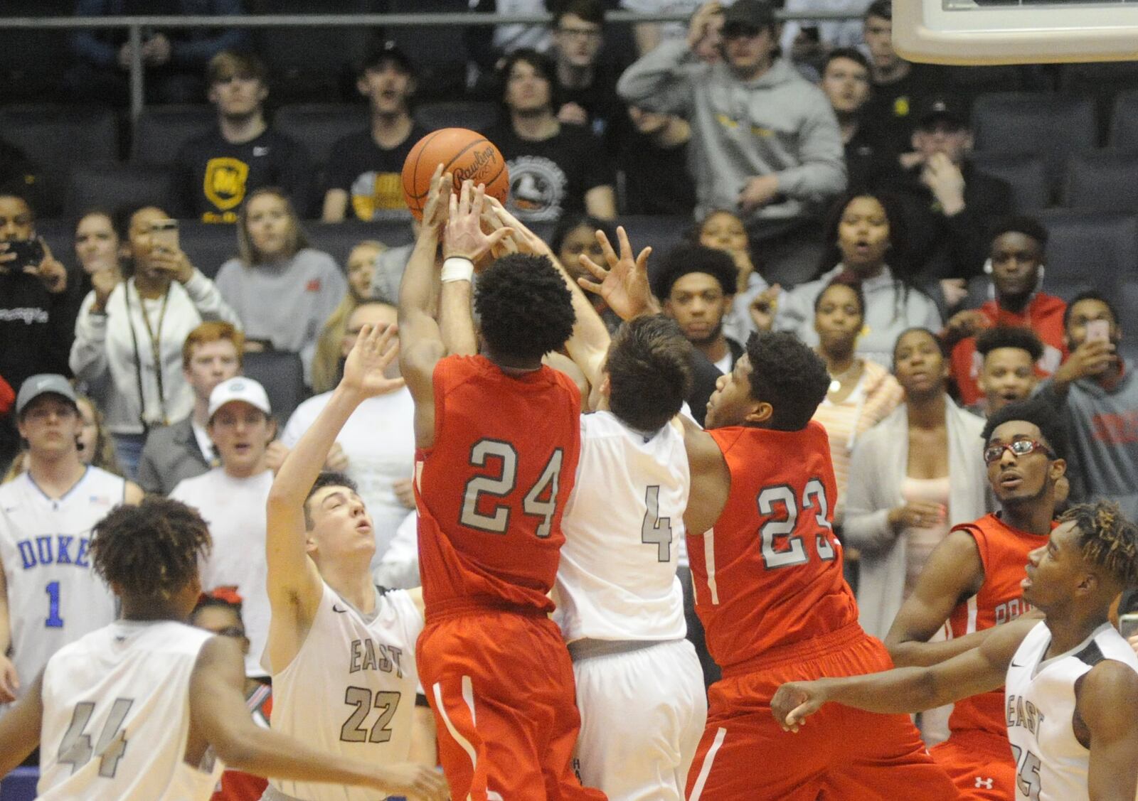 East’s Jalen Peck (44), Bash Wieland (22), Jackson See (4) and Jarrett Cox (right) battle Princeton’s Darweshi Hunter (24) and Gabriel O’Neal for a final rebound during a Division I district final at the University of Dayton Arena on March 10, 2018. Princeton won 53-51. MARC PENDLETON/STAFF