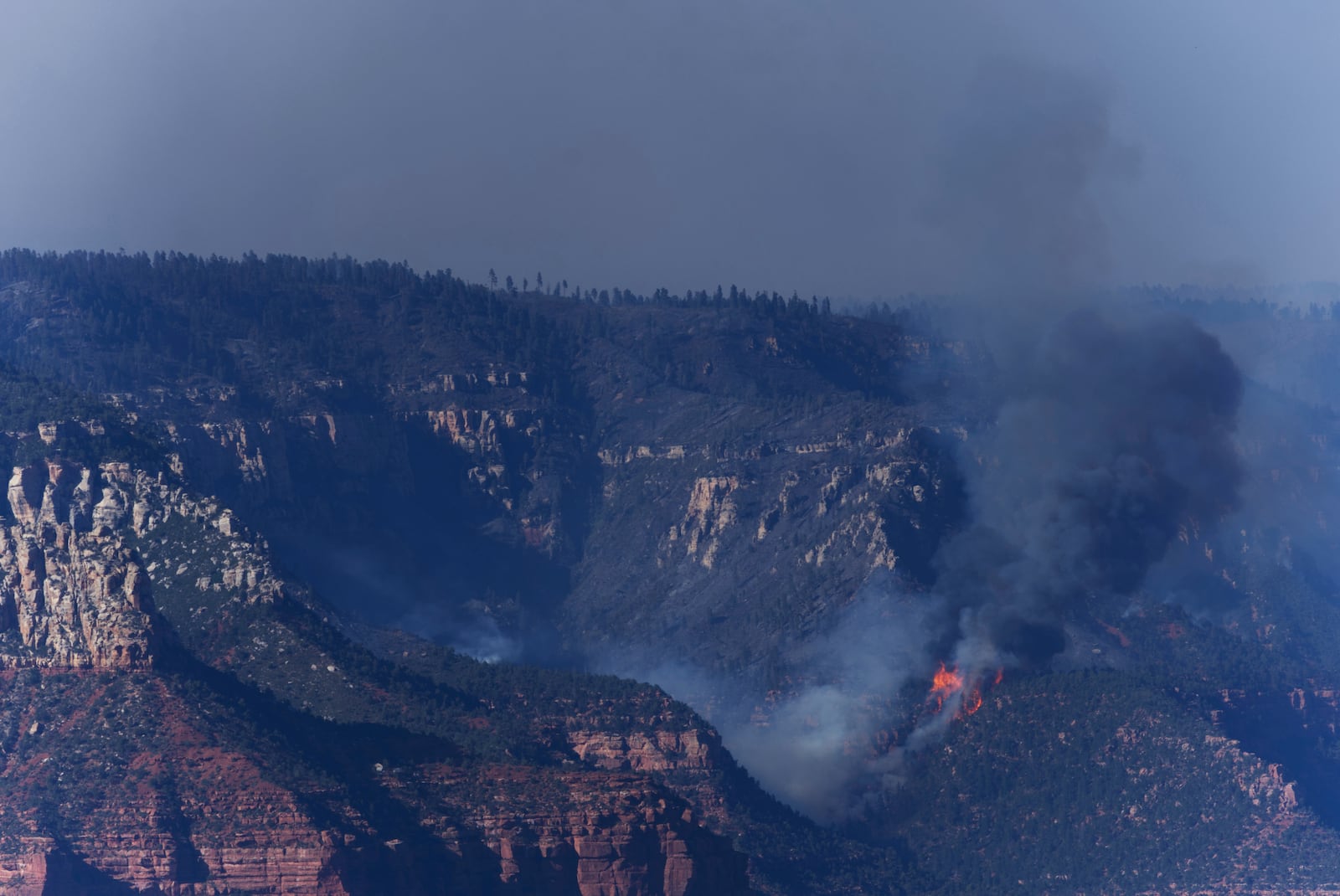 Smoke rises from the Dragon Bravo Fire at the Grand Canyon as seen from Mather Point near Grand Canyon Village, Ariz., Monday, July 28, 2025. (AP Photo/Jon Gambrell)