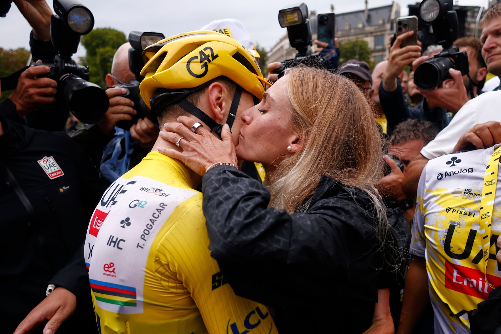 Slovenia's Tadej Pogacar, the Tour de France winner, is greeted by his partner Urska Zigart after finishing, the twenty-first stage of the Tour de France cycling race over 132.3 kilometers (82.1 miles) with start in Mantes-la-Ville and finish on the Champs-Elysees in Paris, France, Sunday, July 27, 2025. (Yoan Valat, Pool Photo via AP)