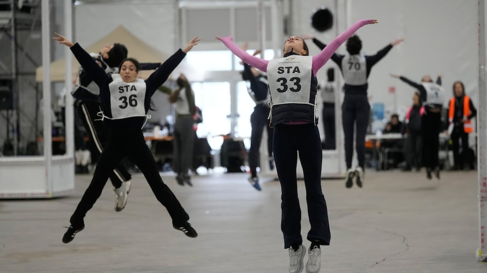 Volunteer dancers perform during rehearsals for the opening ceremony of the Milan Cortina 2026 Winter Olympic Games, at a compound in a big tent next to San Siro Stadium, in Milan, Italy, Saturday, Jan. 24, 2026. (AP Photo/Luca Bruno)