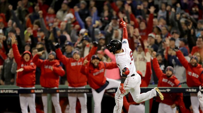 The dugout reacts as Eduardo Nunez #36 of the Boston Red Sox celebrates his three-run home run during the seventh inning against the Los Angeles Dodgers in Game One of the 2018 World Series at Fenway Park on October 23, 2018 in Boston, Massachusetts. (Photo by Elsa/Getty Images)