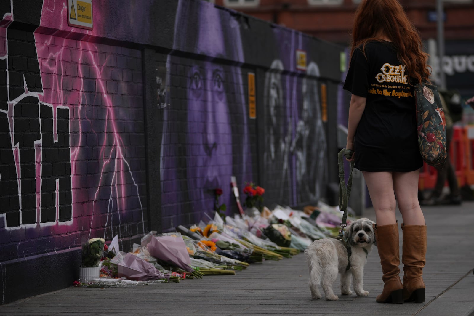 A music fan commemorates the death of Ozzy Osbourne in Birmingham, Wednesday, July 23, 2025. (AP Photo/Kin Cheung)