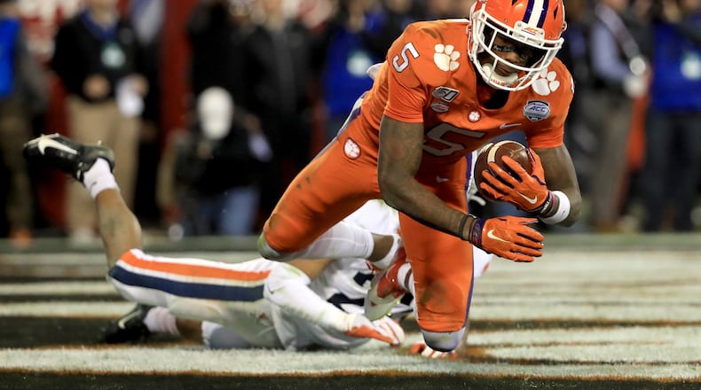 CHARLOTTE, NORTH CAROLINA - DECEMBER 07: Heskin Smith #23 of the Virginia Cavaliers watches as Tee Higgins #5 of the Clemson Tigers catches a touchdown during the ACC Football Championship game at Bank of America Stadium on December 07, 2019 in Charlotte, North Carolina. (Photo by Streeter Lecka/Getty Images)