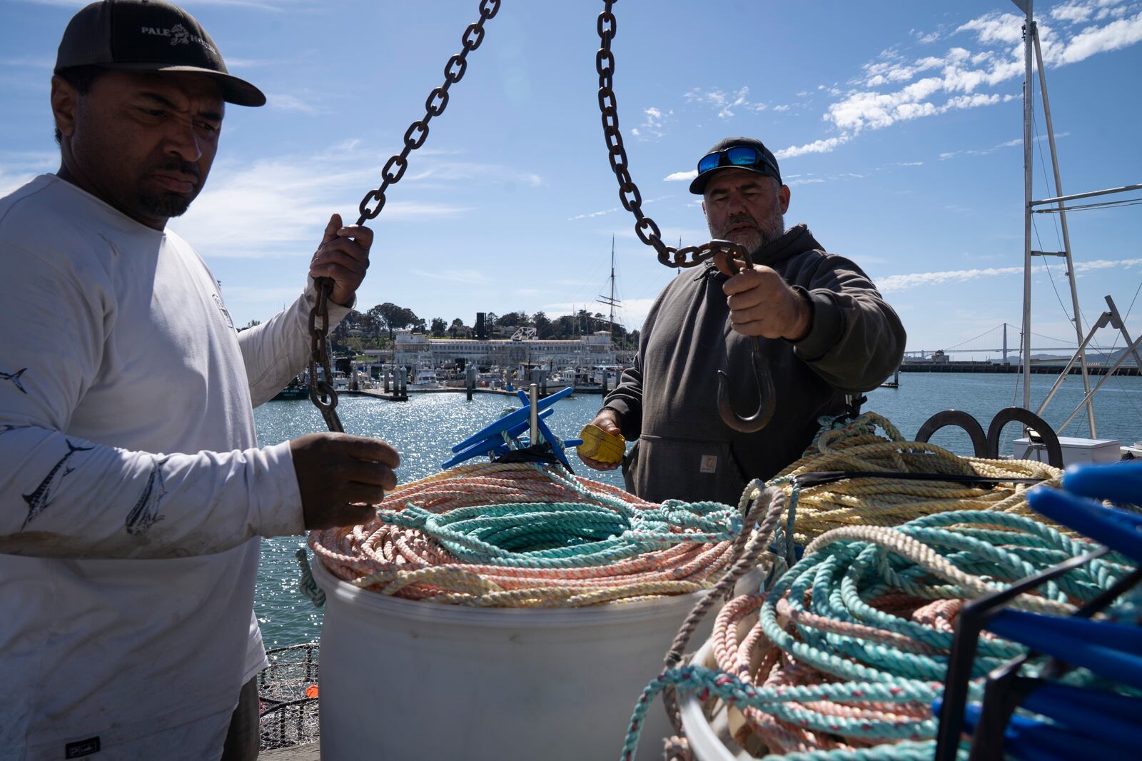 James Sanders, left, and Brand Little, load rope onto Little's boat Pale Horse at Pier 45 in San Francisco, Thursday, April 10, 2025. Little is part of a pilot program using pop-up gear to protect whales. (AP Photo/Emily Steinberger)
